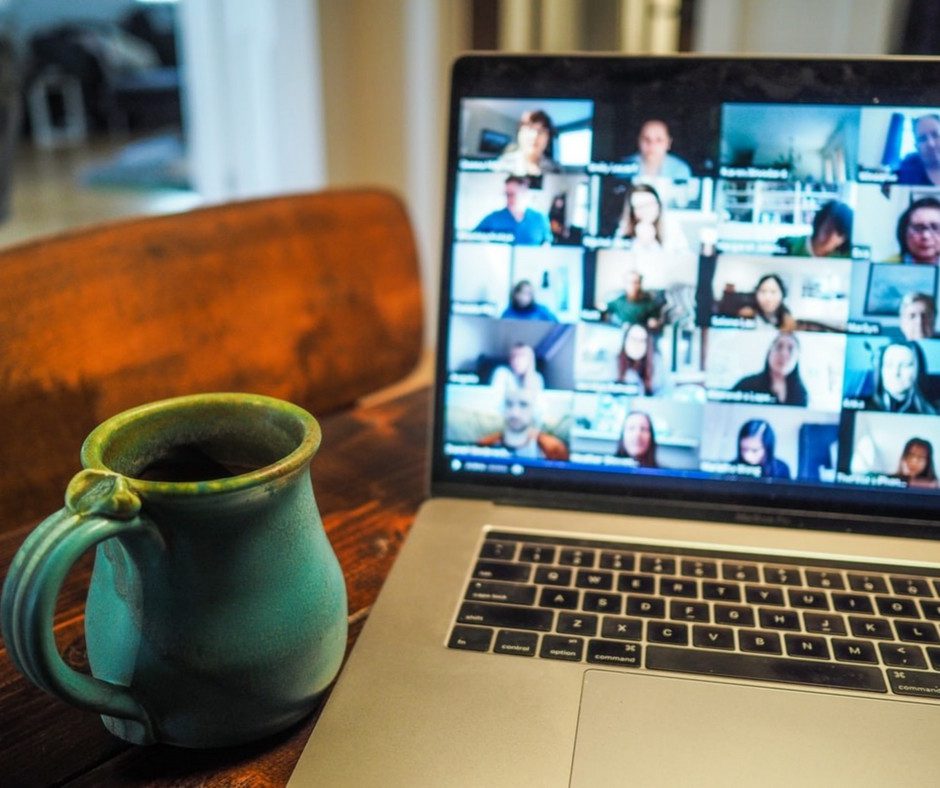 Mug and laptop with virtual meeting