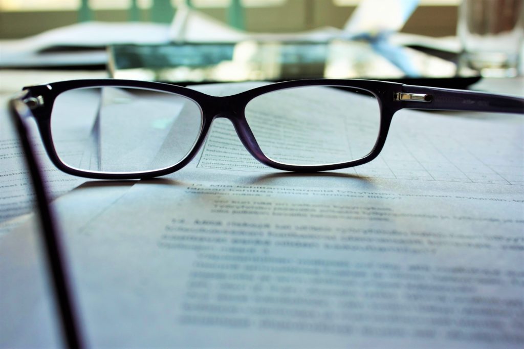 Pair of glasses on papers
